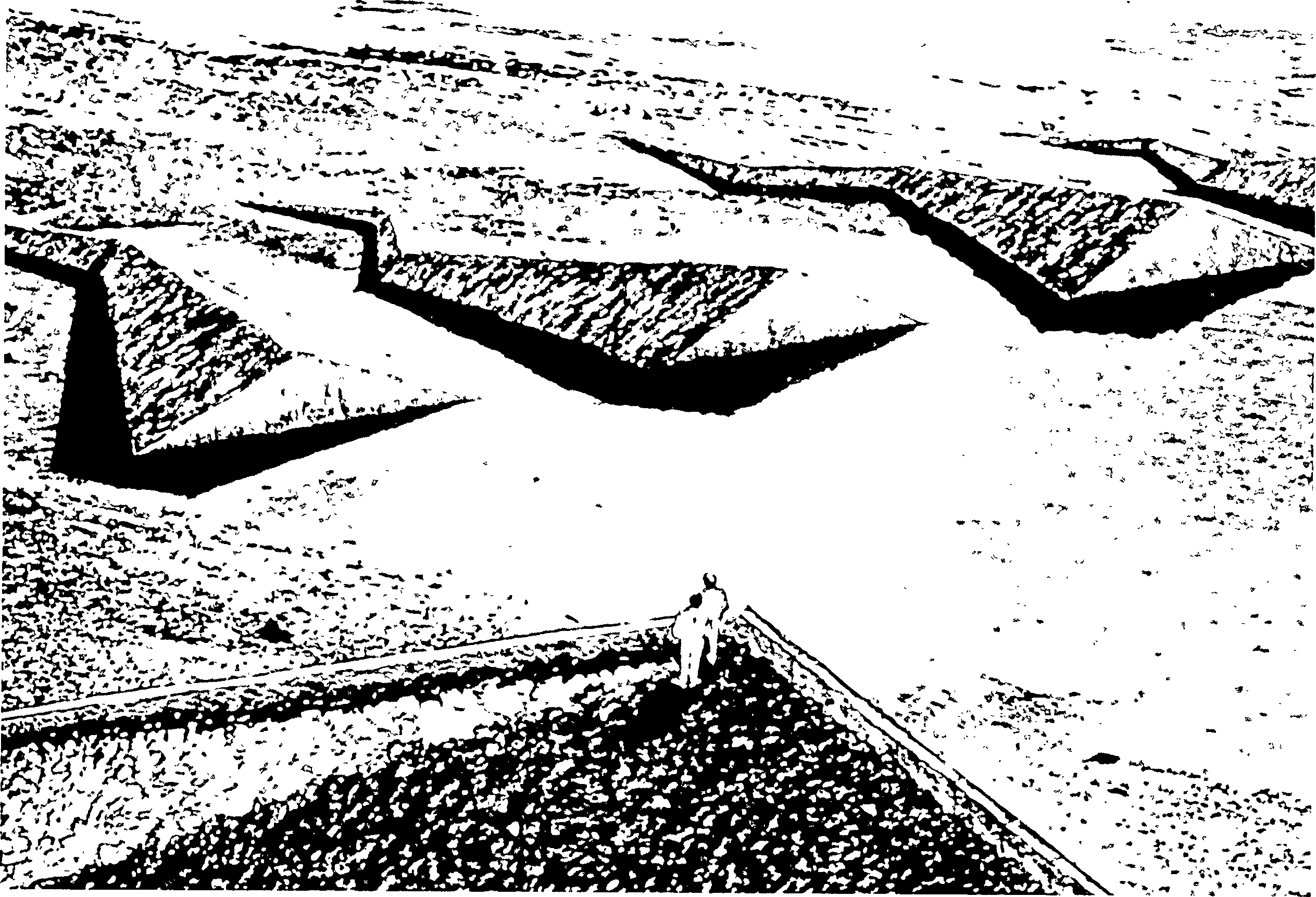 Drawing of two people standing within a boundary of zig-zag emanating rays. Each ray is sloped down each side, and narrows to a point at the outer edge.